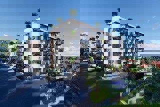 Attraente appartamento con due camere da letto in un edificio di nuova costruzione con vista parziale sul mare