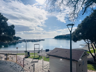 Istra, Pula, Pješčana uvala, vendita di un appartamento su due livelli con garage, prima fila al mare.