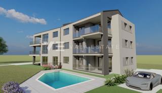 APPARTAMENTO AL PIANO TERRA CON GIARDINO E PISCINA CONDOMINIALE