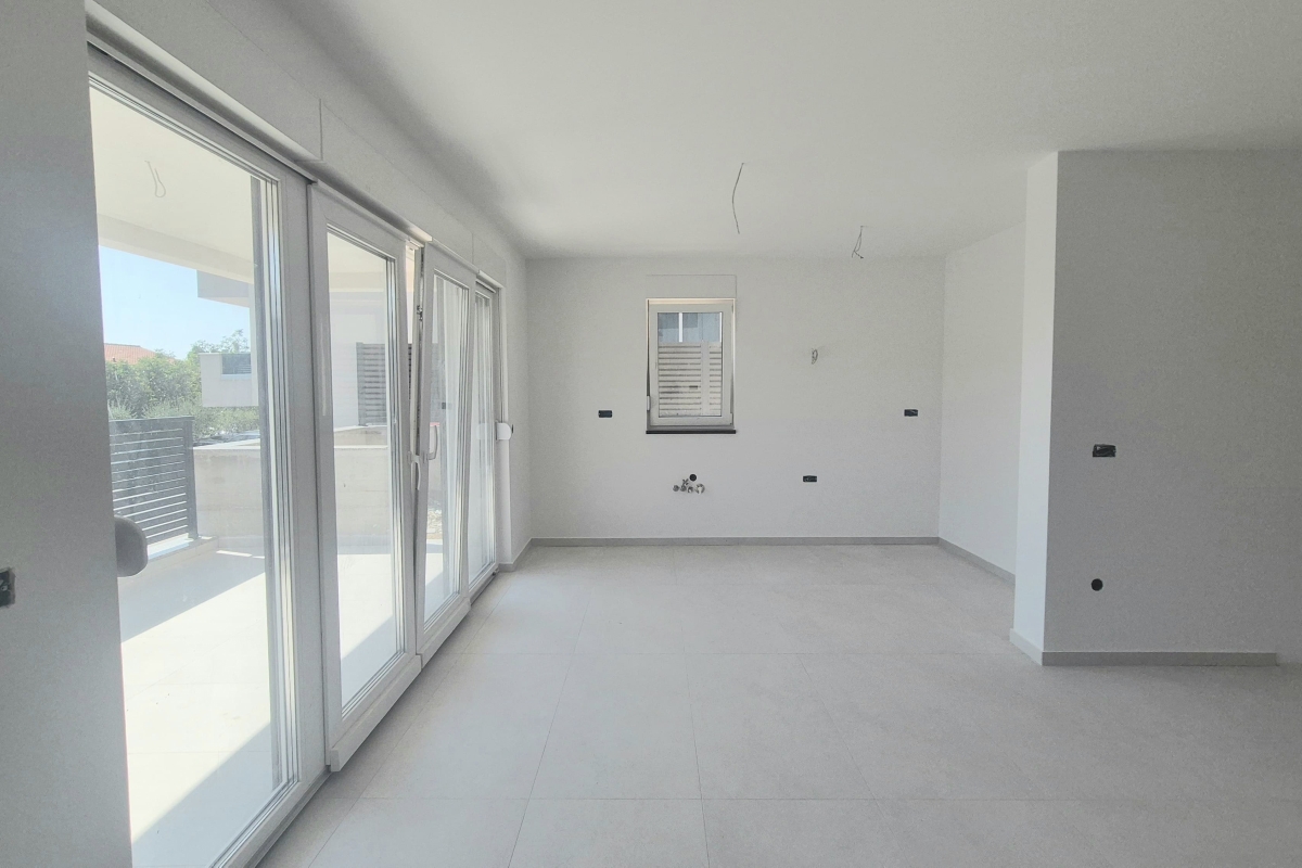Appartamento in un nuovo edificio con giardino e posto auto