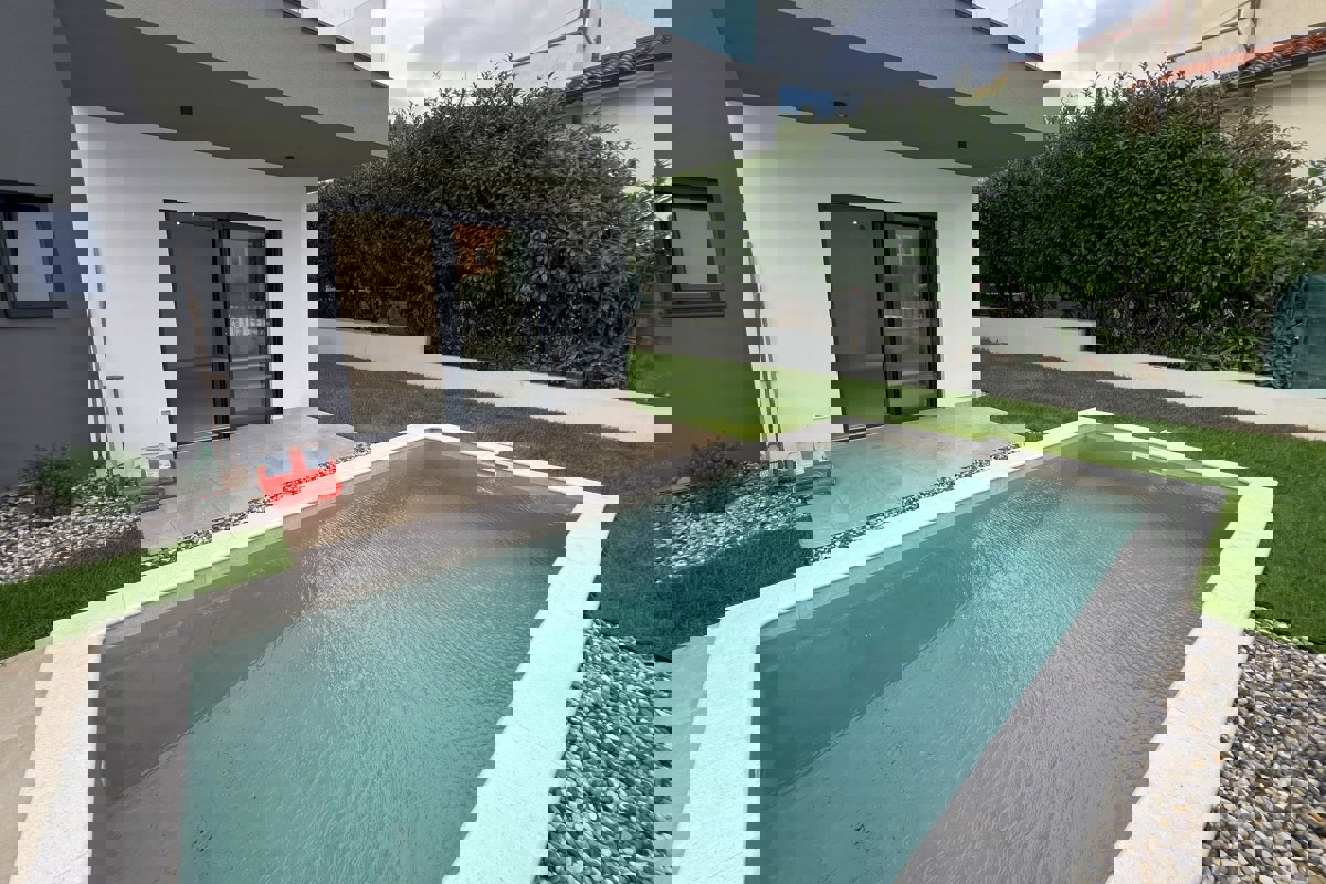 Appartamento al piano terra con piscina privata, cortile e disposizione funzionale