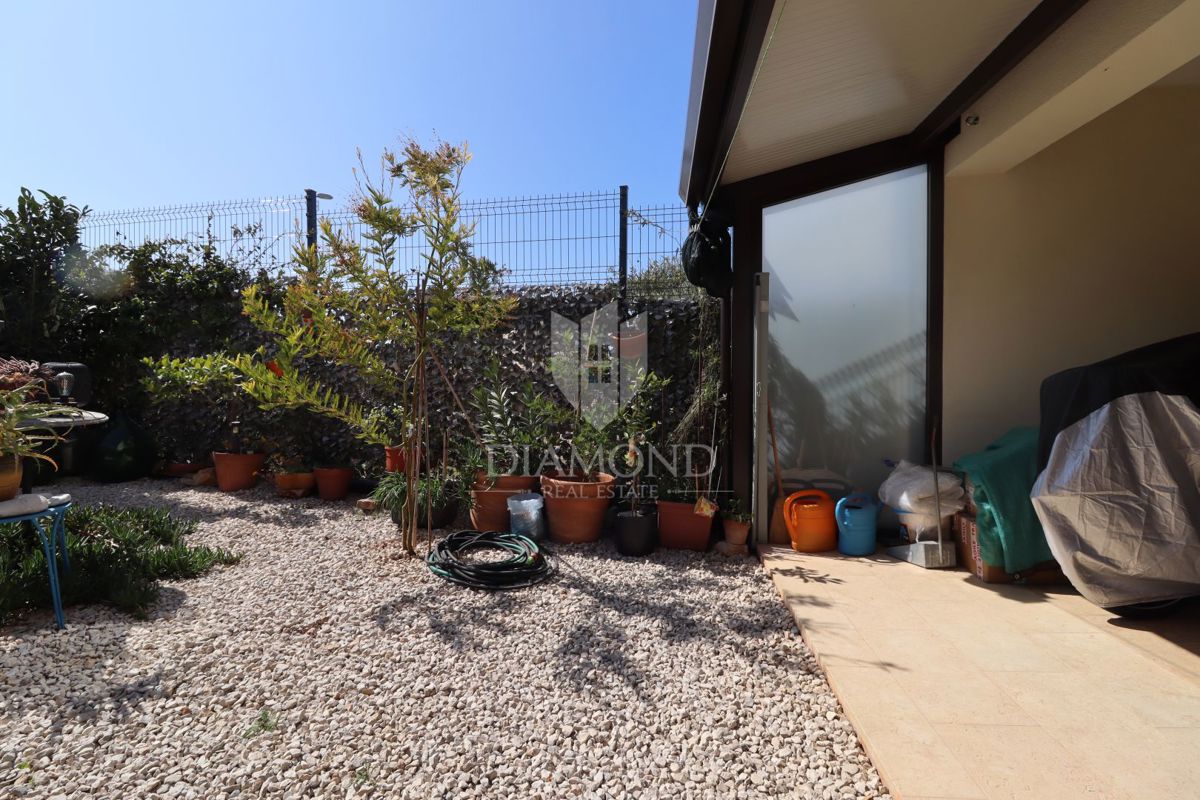 Nuova costruzione! Appartamento trilocale al piano terra con ampio giardino e parcheggio. A 1 km dal mare, nel centro del paese.