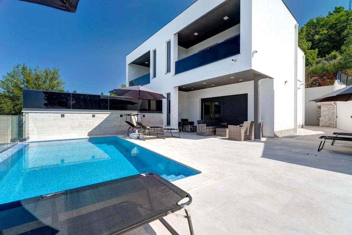 Modern house with a pool and a panoramic view of the sea