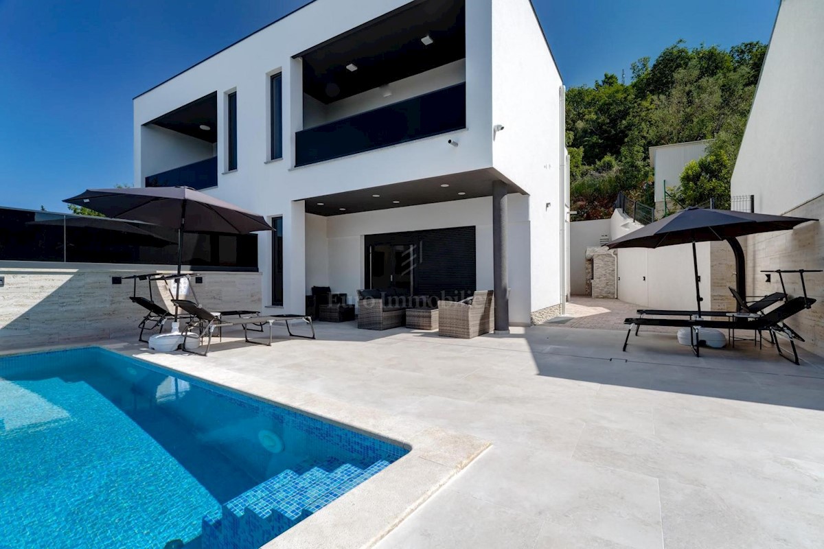 Modern house with a pool and a panoramic view of the sea