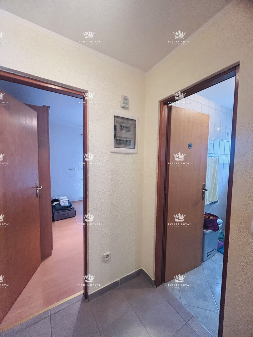 Istra, Umag, appartamento 61m2, 1 camera da letto + soggiorno, più monolocale di 16m2 nel seminterrato, cortile 79m2, 2 posti auto 38m2, frazionato, documenti in regola, vista mare