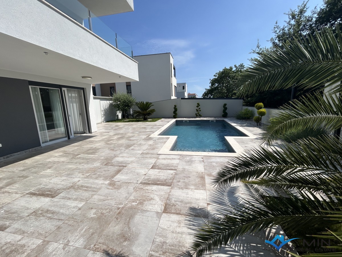 Appartamento top, piscina riscaldata, giardino da sogno di facile manutenzione, posto auto coperto con serratura per 4 auto